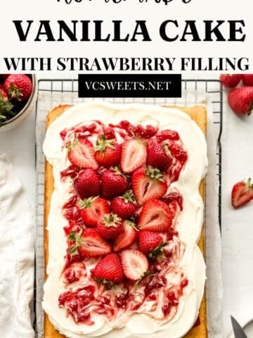 Vanilla cake with strawberry filling on a wire rack.