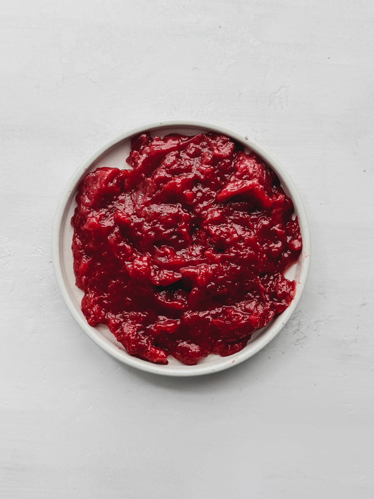 Strawberry cake filling on a small plate.