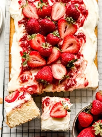 Overhead view of sliced vanilla cake with strawberry filling.