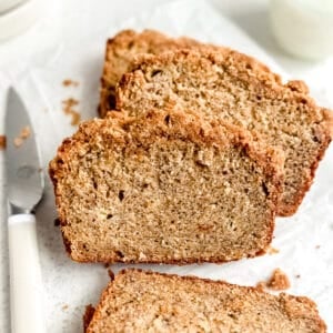Slices of banana bread with streusel topping laying on top of each other.