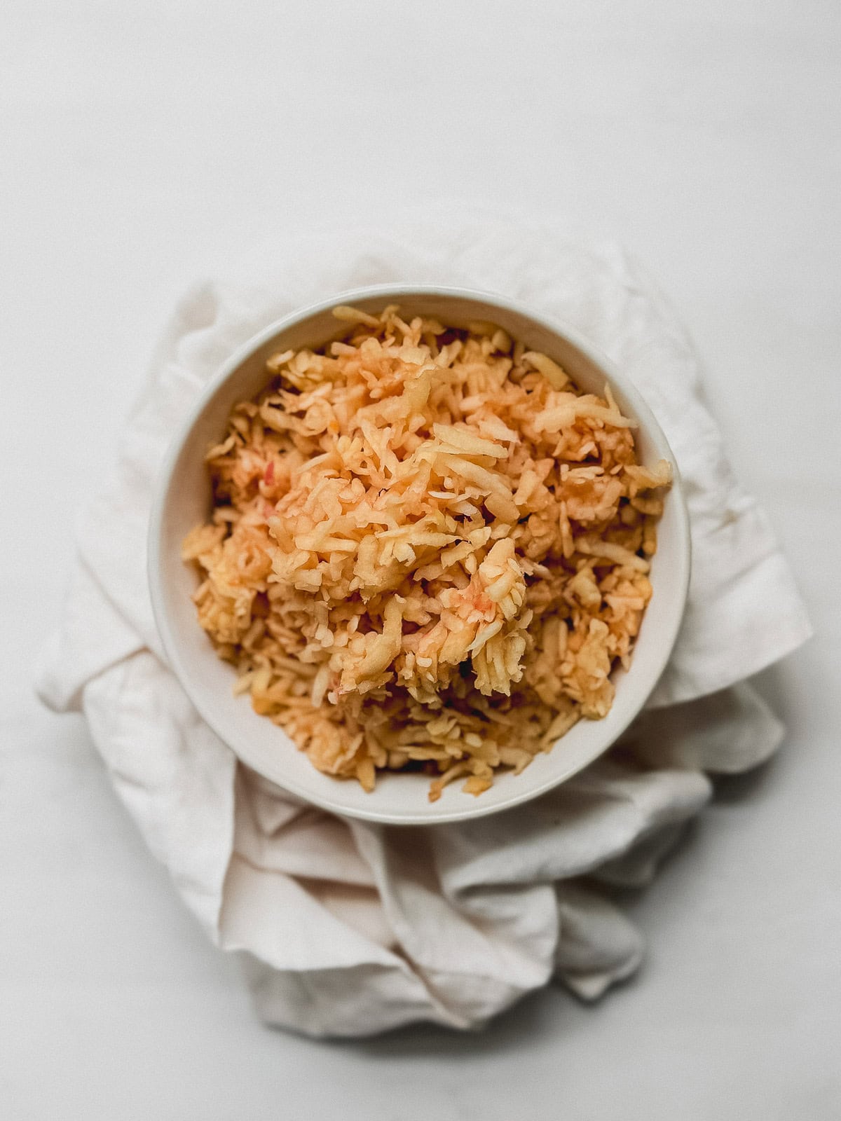 Shredded apples in a bowl.