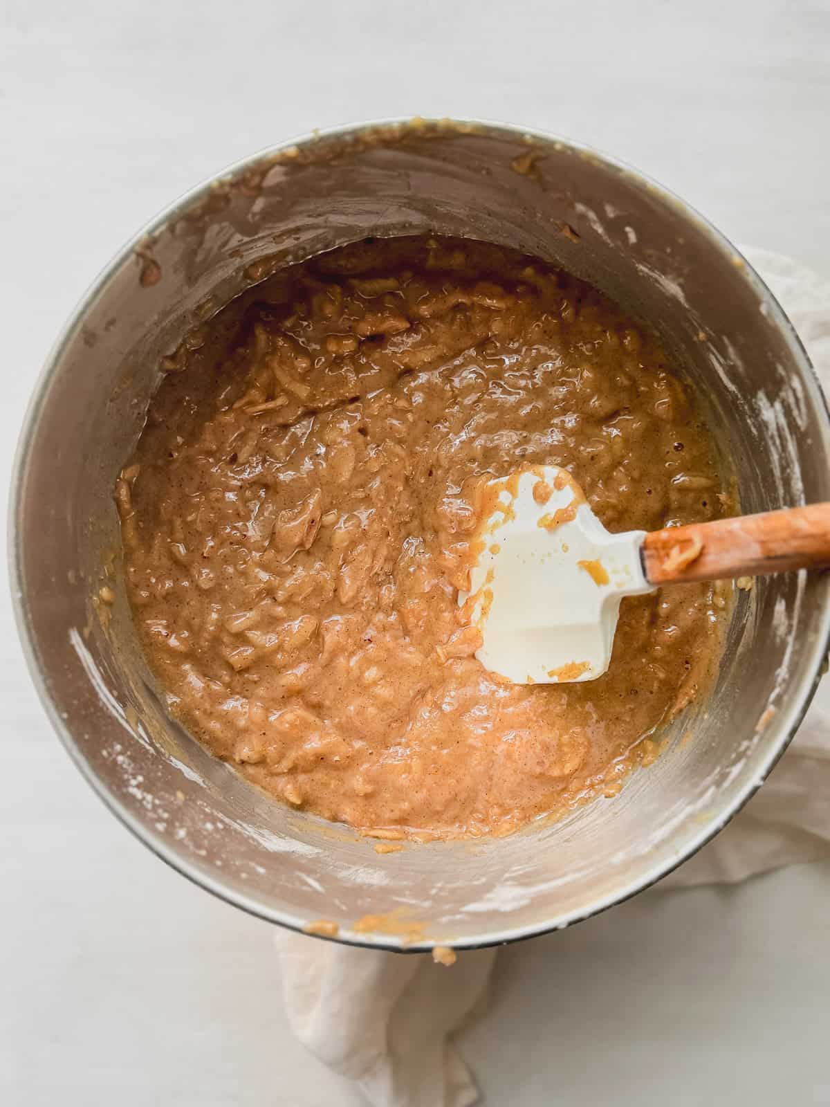 Apple cake batter in a mixing bowl after folding in the dry ingredients.